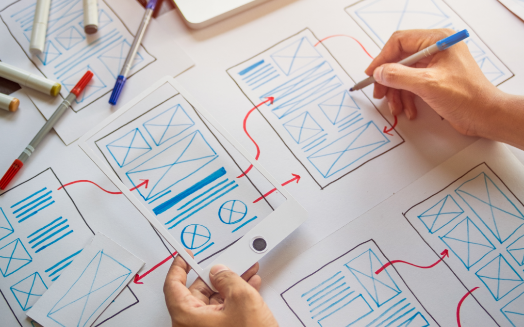 person sketching wireframes for mobile friendly manufacturing website